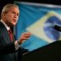 US President George W Bush talks with the Brazilian flag on the background