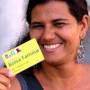 A Brazilian woman flashes her Bolsa FamÃ­lia (Family Grant) card