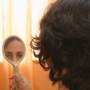 Brazilian Mirna looks at her new hair in the mirror