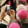 A Brazilian bishop takes a picture of the pope