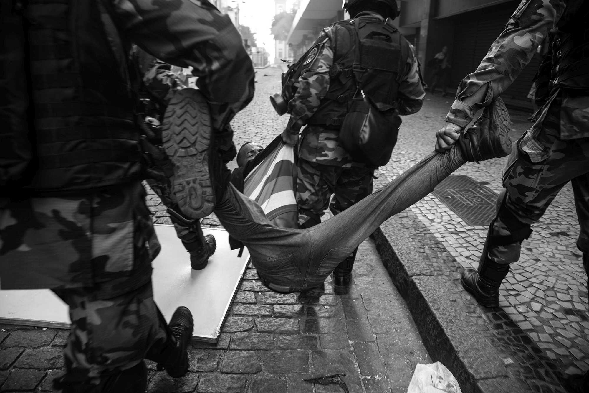 Police drag protester in Rio - Photo by Pedro Prado