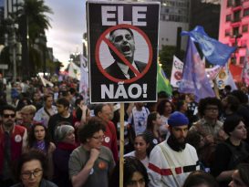 Protesters in the streets against Bolsonaro. "Not him,"says the sign