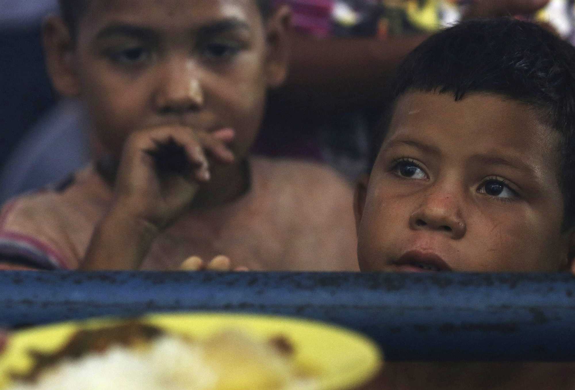 Venezuelan kids wait for a meal at a migrant shelter in Boa Vista, Roraima state, Brazil - Eraldo Peres/AP