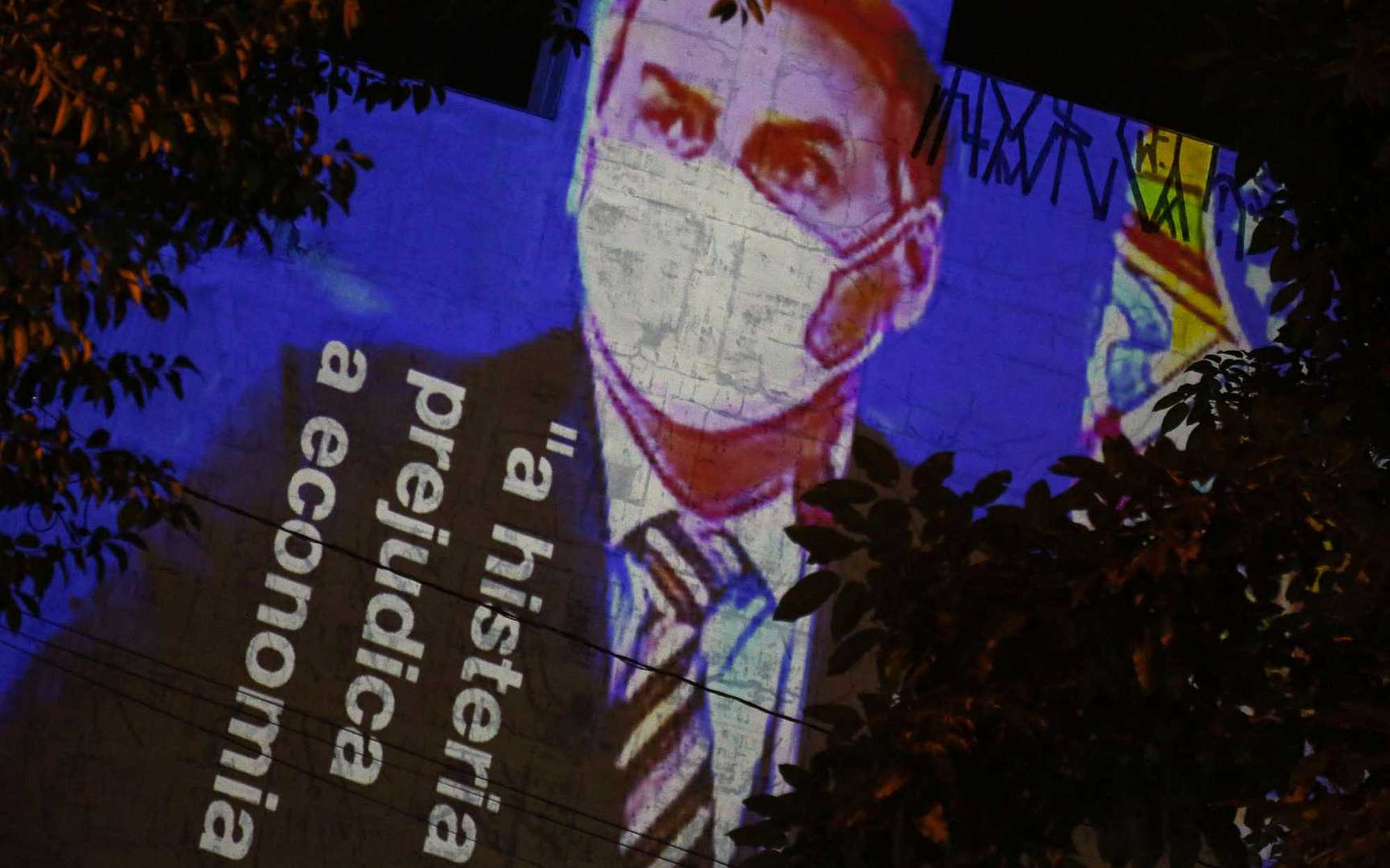 A signboard with the figure of Jair Bolsonaro and the inscription "Hysteria hurts economy" over him.