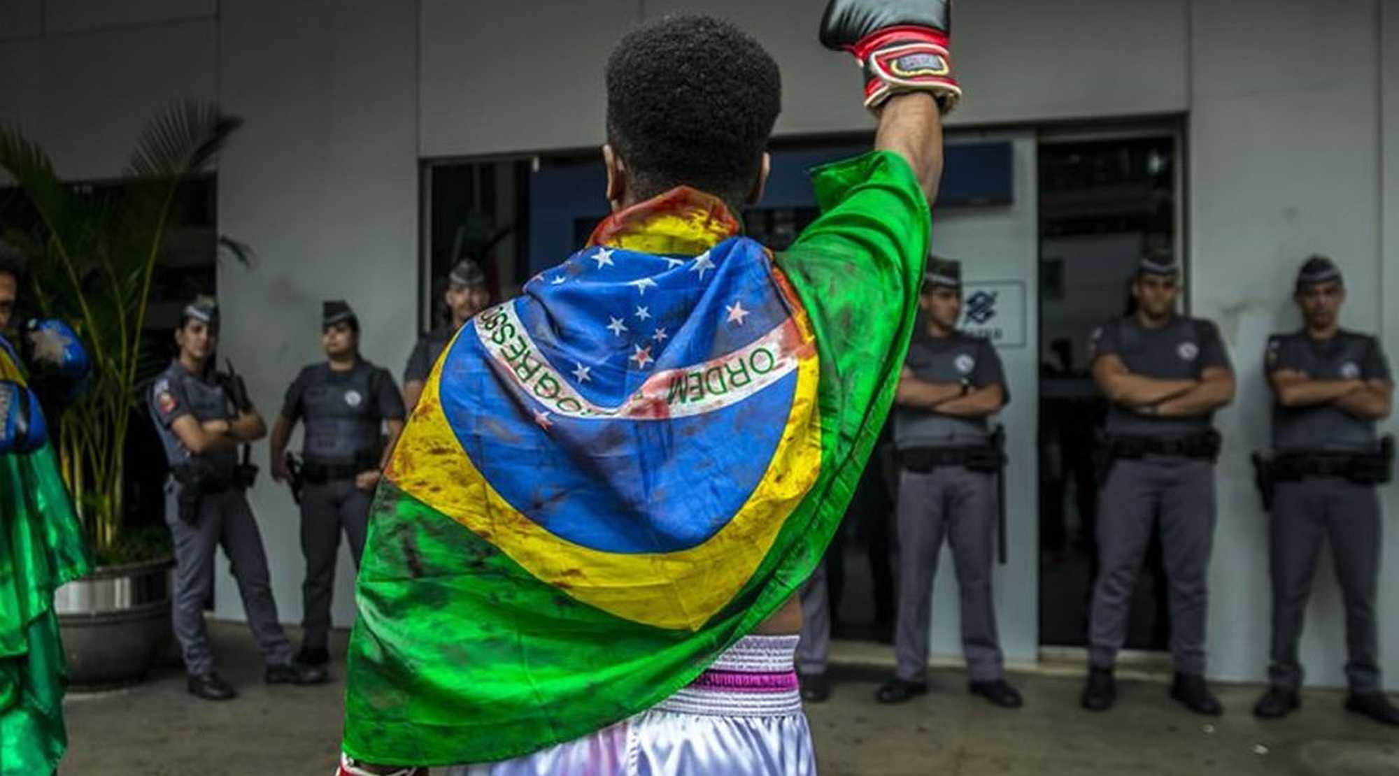 Wrapped in the Brazilian flag, black man participates in the Black Conscience March, in São Paulo | NurPhoto/PA Images