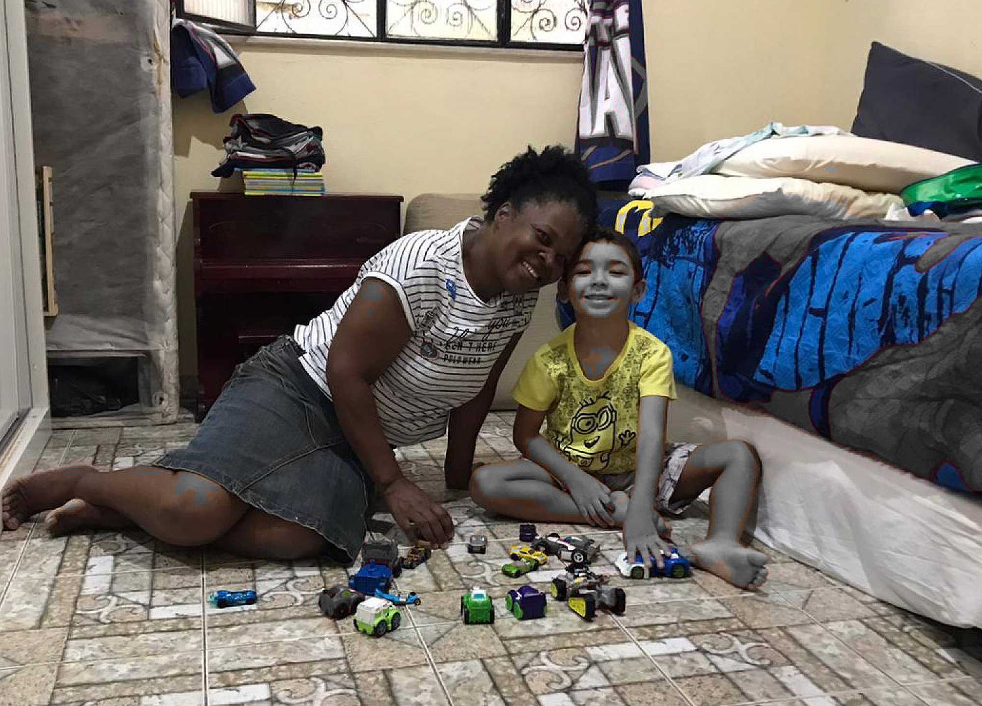 A maid taking care of the employer's kid.