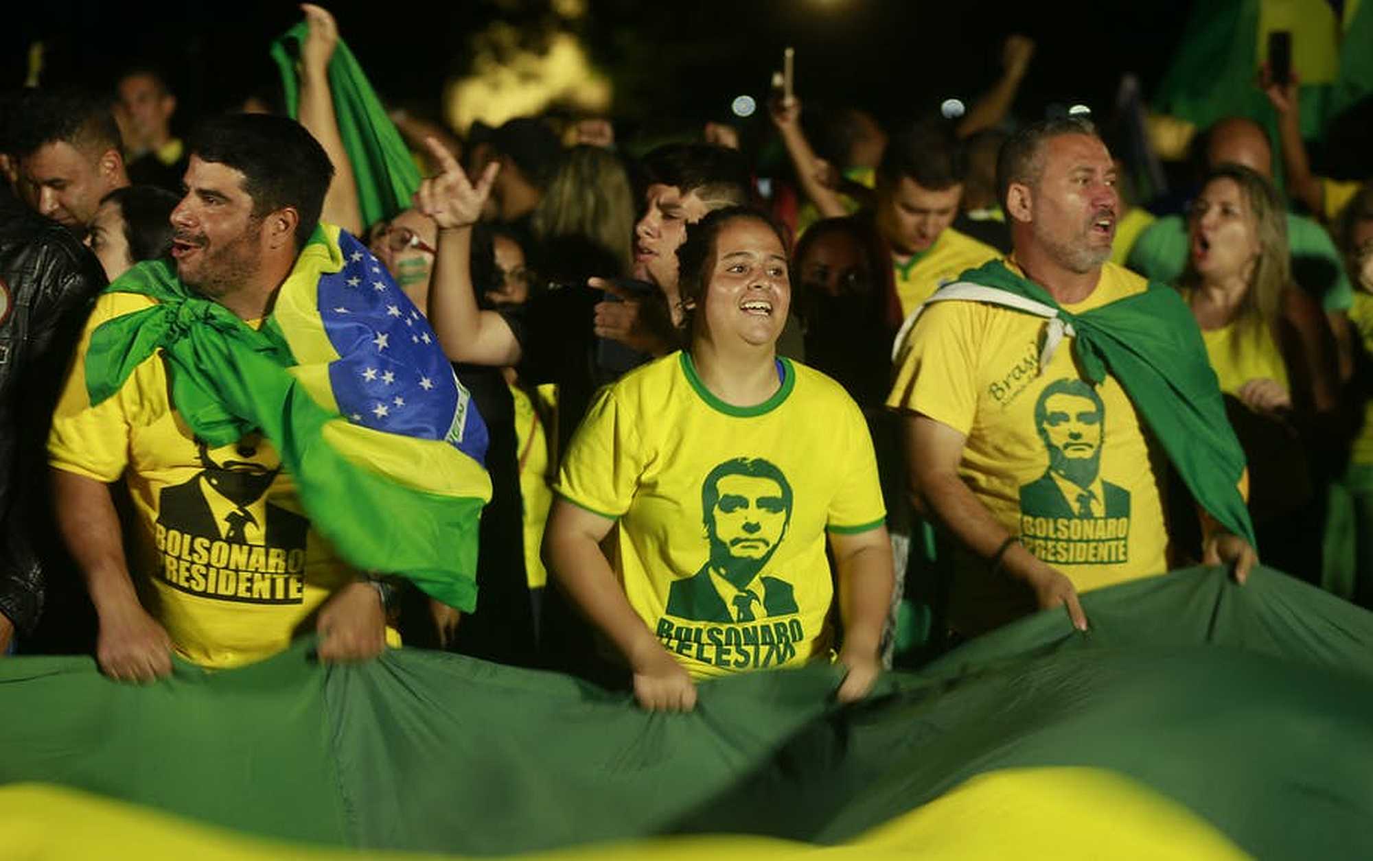 Crowd wearing T-shirts with Jair Bolsonaro's face on. Victory: supporters of Jair Bolsonaro celebrate in October 2018. Joedson Alves/EPA