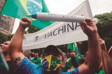 The protestors in São Paulo rallied in support of Bolsonaro, with one demonstrator holding a sign saying "We are not guinea pigs"