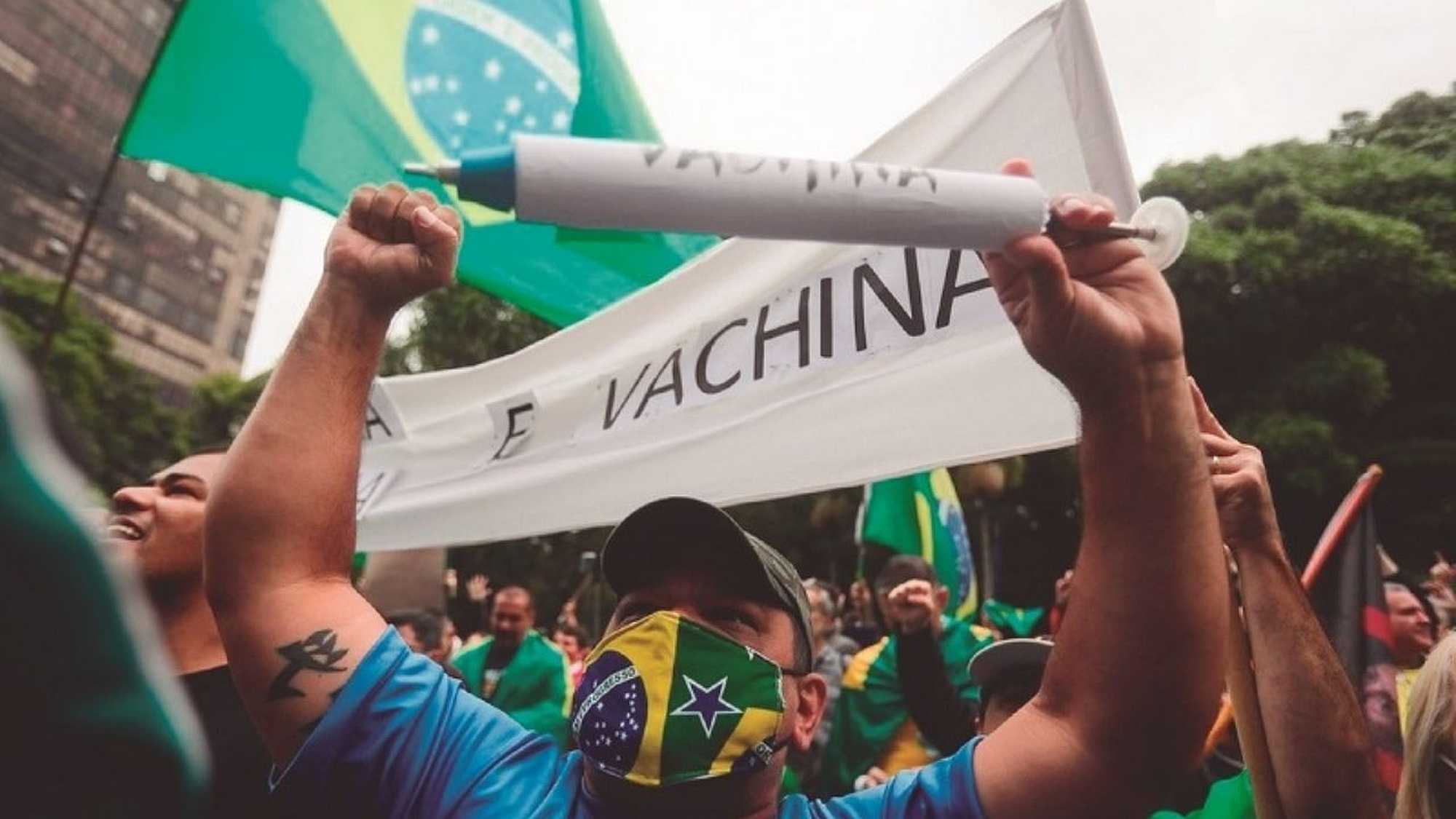 The protestors in São Paulo rallied in support of Bolsonaro, with one demonstrator holding a sign saying "We are not guinea pigs"