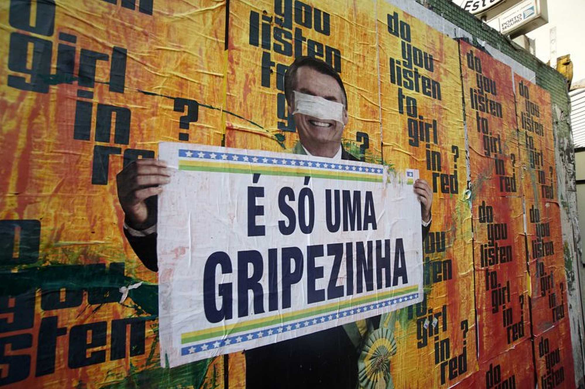 A mural showing Bolsonaro holding a sign that says: 'It's just a minor cold' | Cris Faga/NurPhoto/PA Images