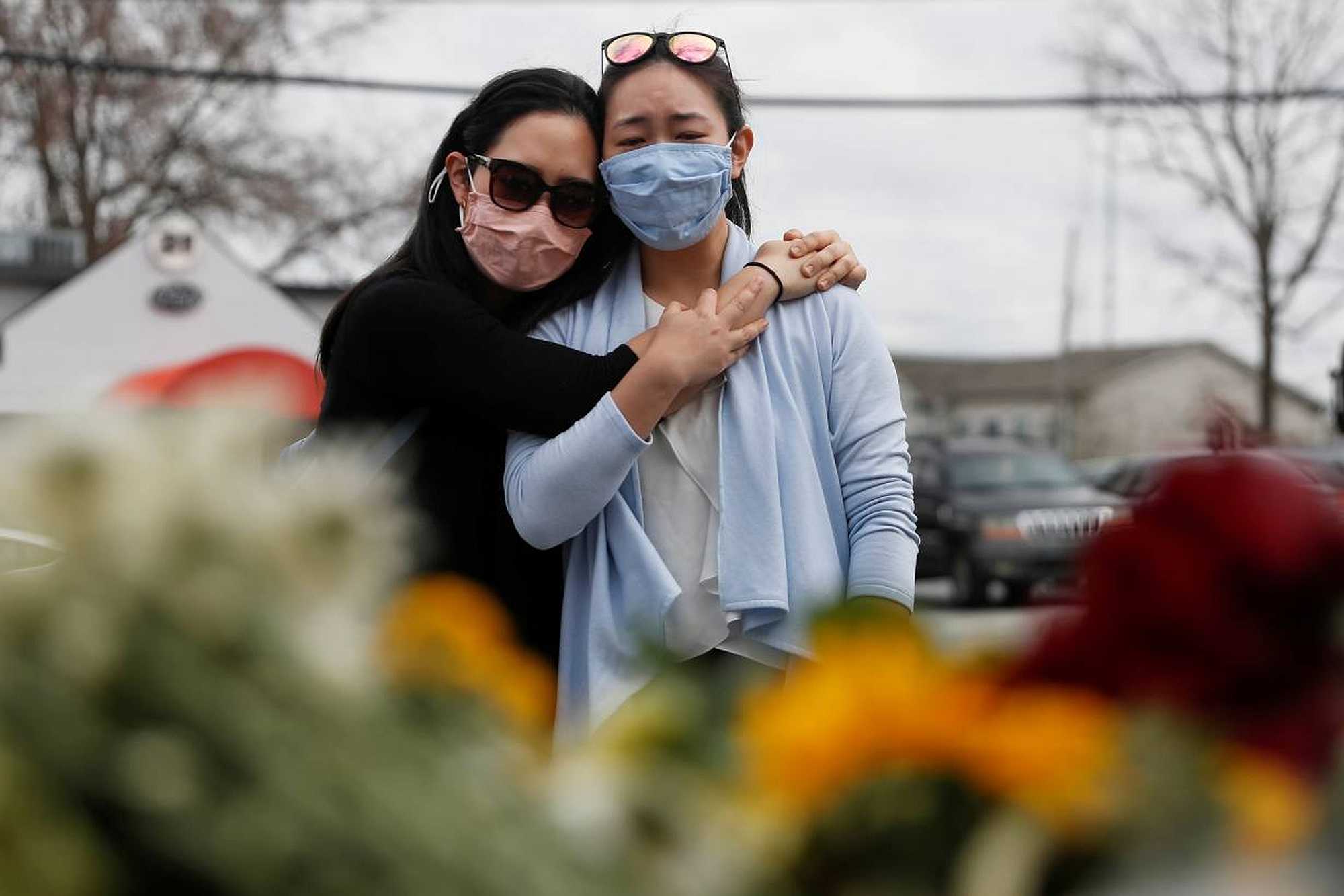 Helen Park Truong, 34, and Sarah Tang, 31, embrace after laying flowers at a makeshift memorial outside the Gold Spa REUTERS/Shannon Stapleton