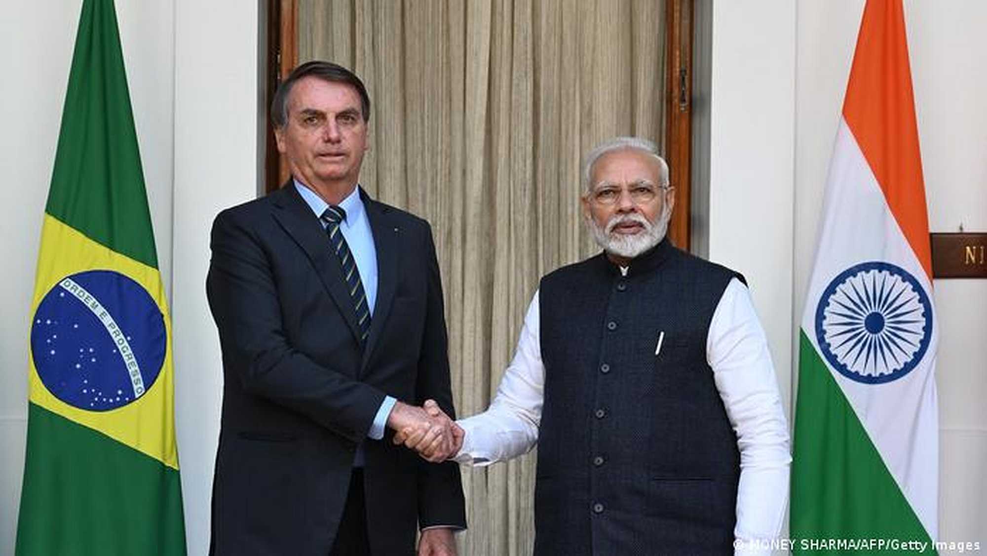 Jair Bolsonaro and Narendra Modi shake hands at a 2020 meeting