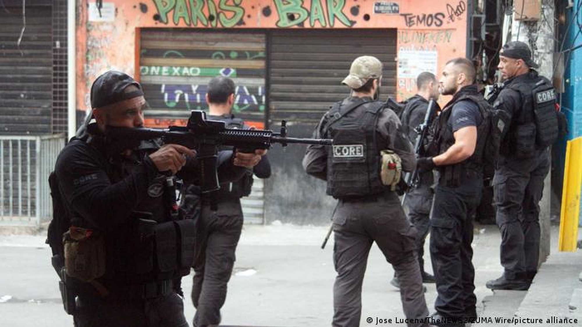 Armed police raid a slum in Rio de Janeiro