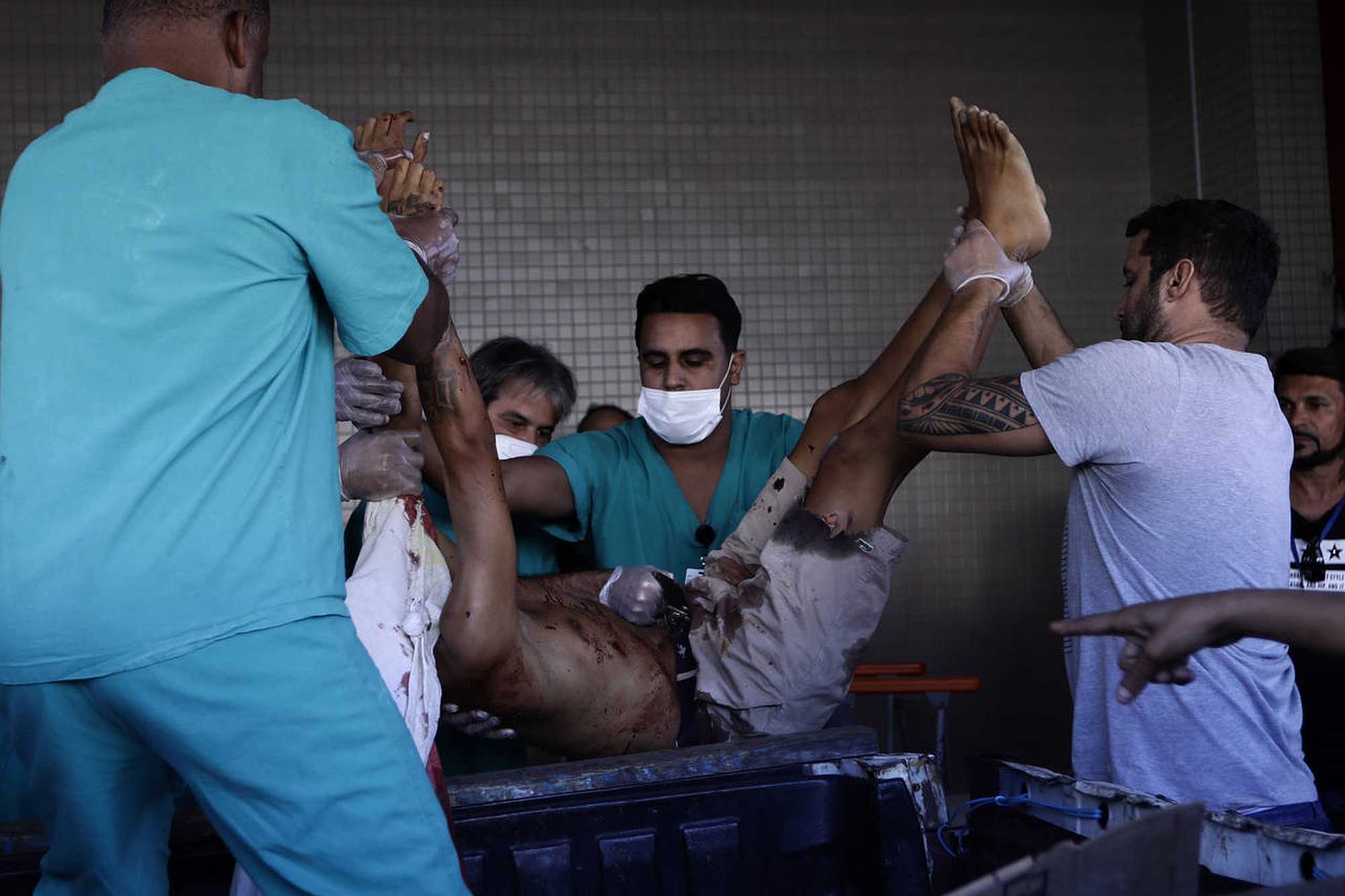 Health workers gather around an injured man in Rio