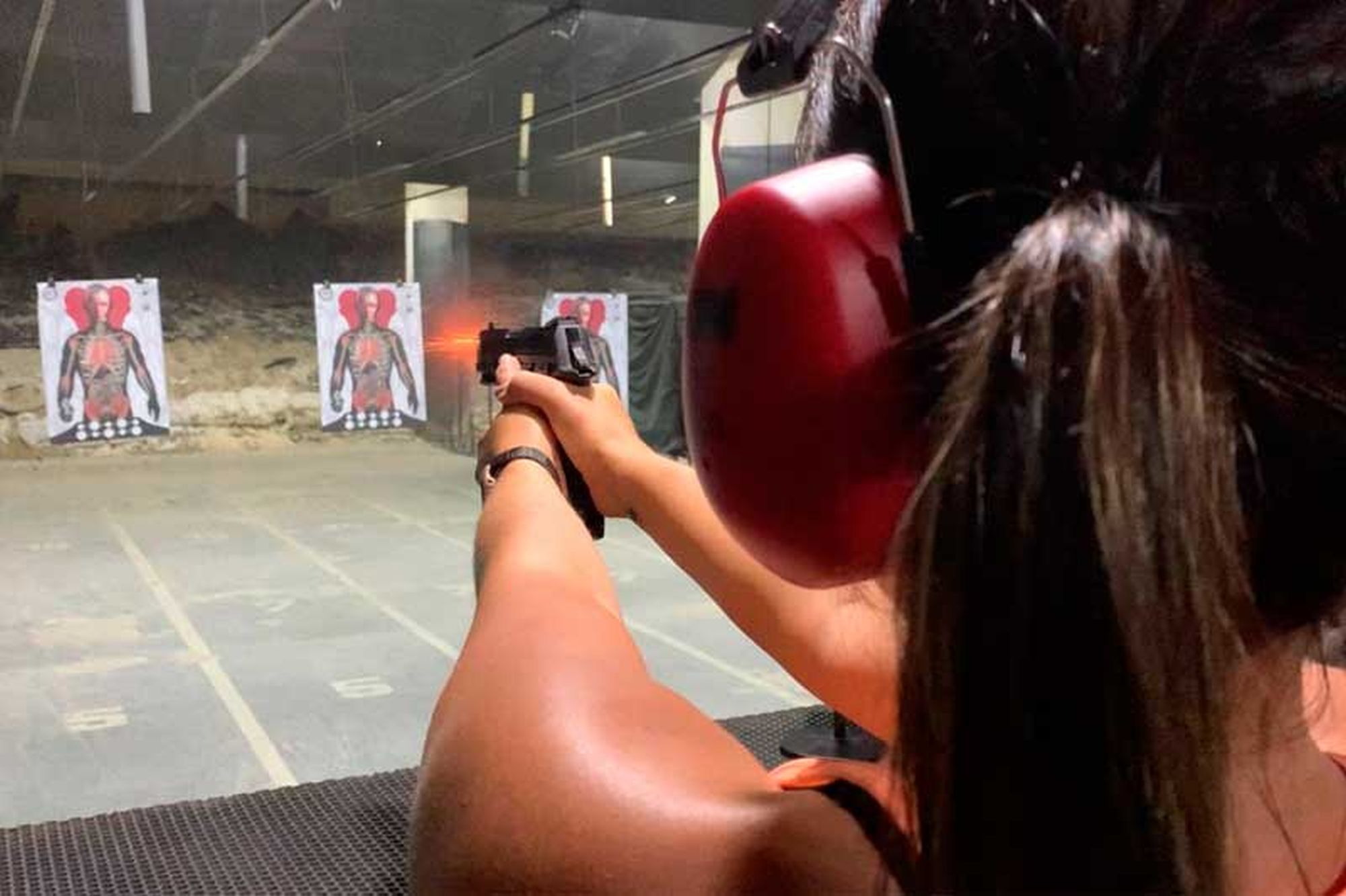 A young woman practices shooting in a gun club in Brazil.