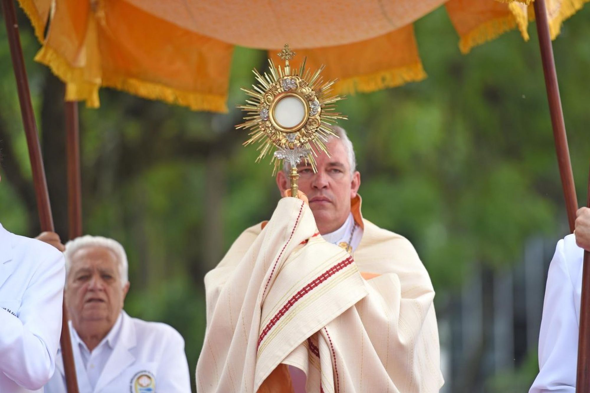Priest carries the holy host during a Corpus Christi procession in the state of Paraná