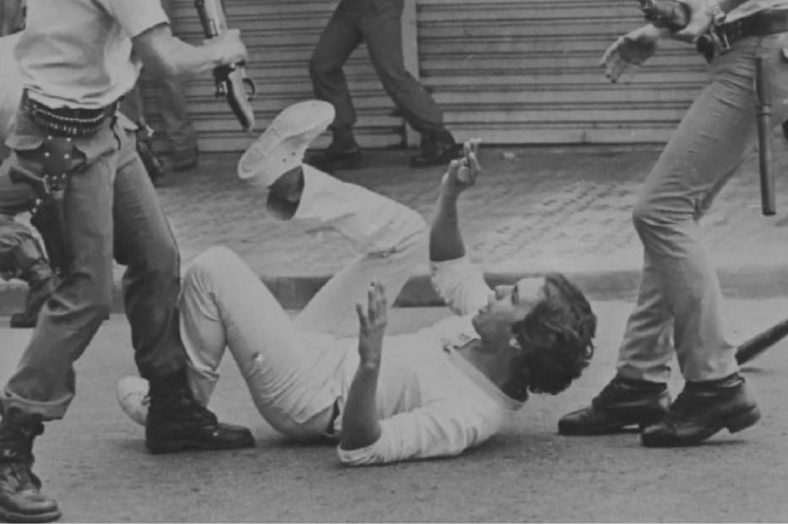 A protester being beaten by the police during the dictatorship