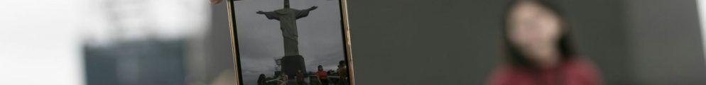 A tourist captures a moment in front of the Christ the Redeemer statue in Rio.